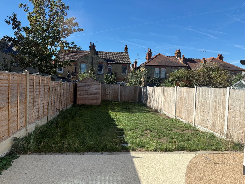 Lot: 132 - THREE-BEDROOM TERRACE HOUSE - Rear garden with patio and shed